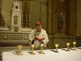GT Walsh consecrating chalices2 May 14 2010.jpg